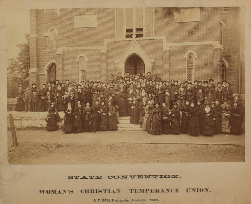 A large group of women is standing outside of the College Avenue M.E. Church in Greencastle, Indiana.
