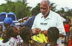 Pastor Frank Alexander working with children in Liberia as part of the nonprofit he started, Oasis Mission for Orphans, Disabled and Unaccompanied Children, ca. 1990s 