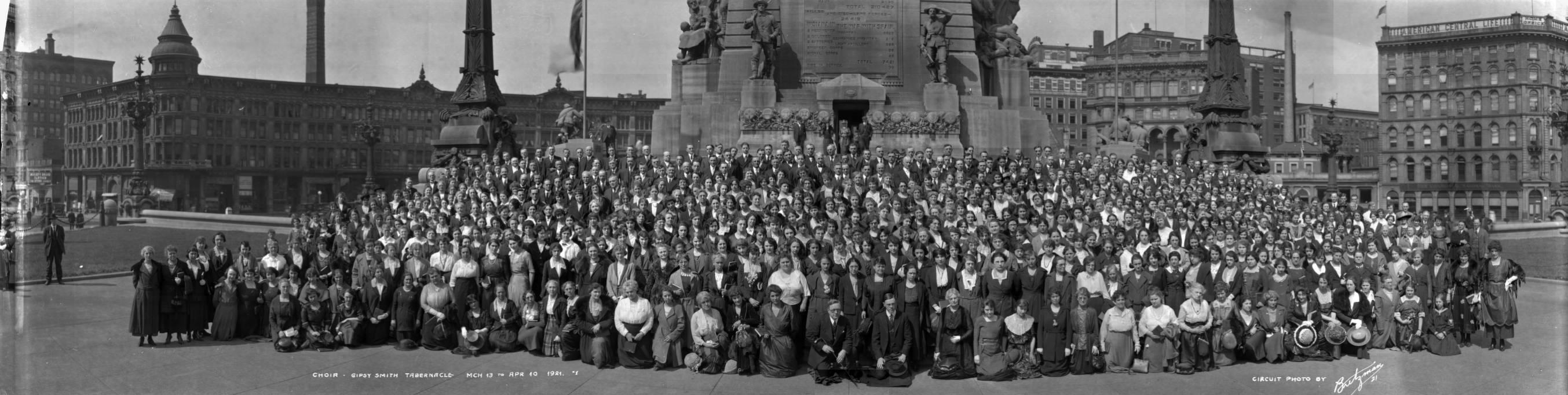 A large group of people gather together for a photograph.