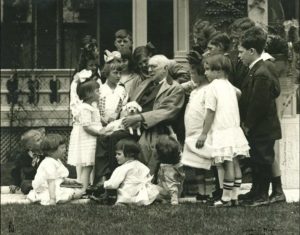 An iconic photo of James Whitcomb Riley surrounded by children, 1916