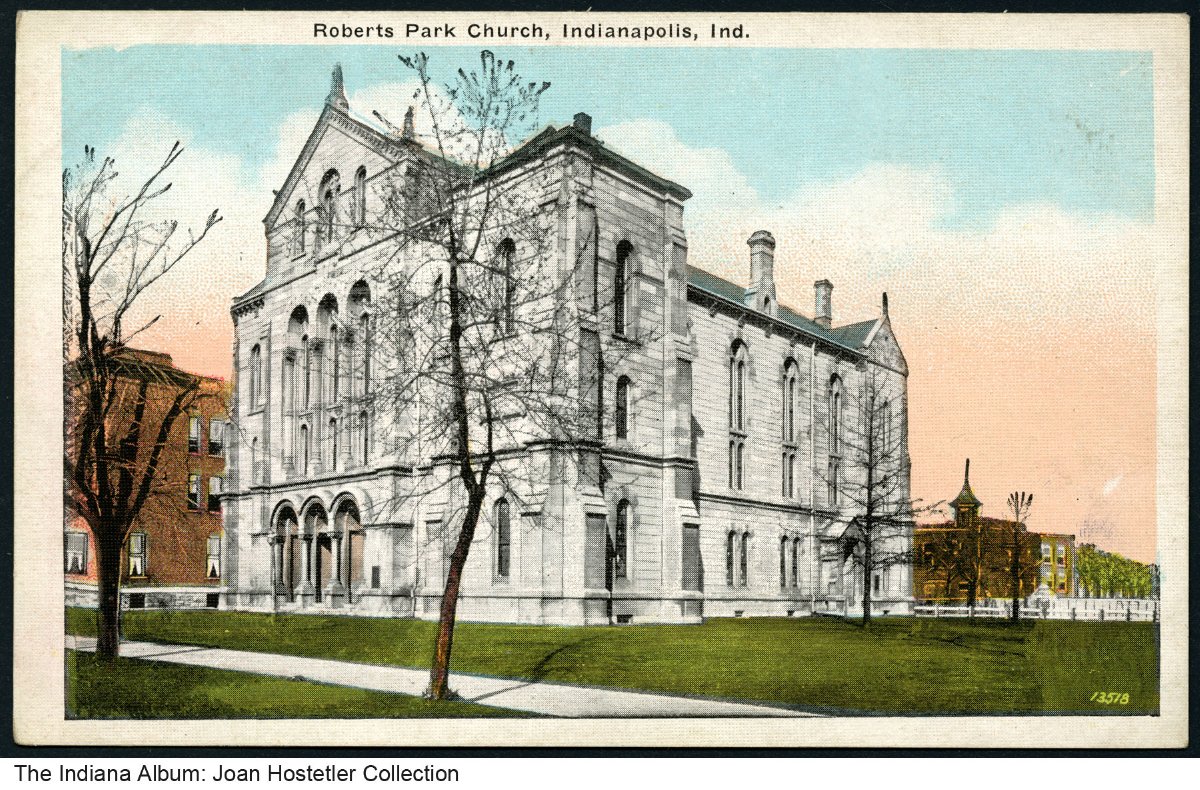 A postcard featuring a large church with arched entrances and columns.