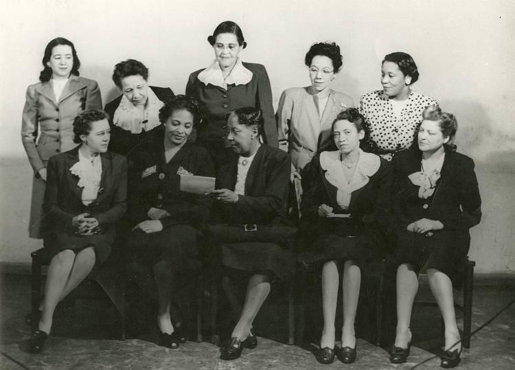A group of woman sit together. 