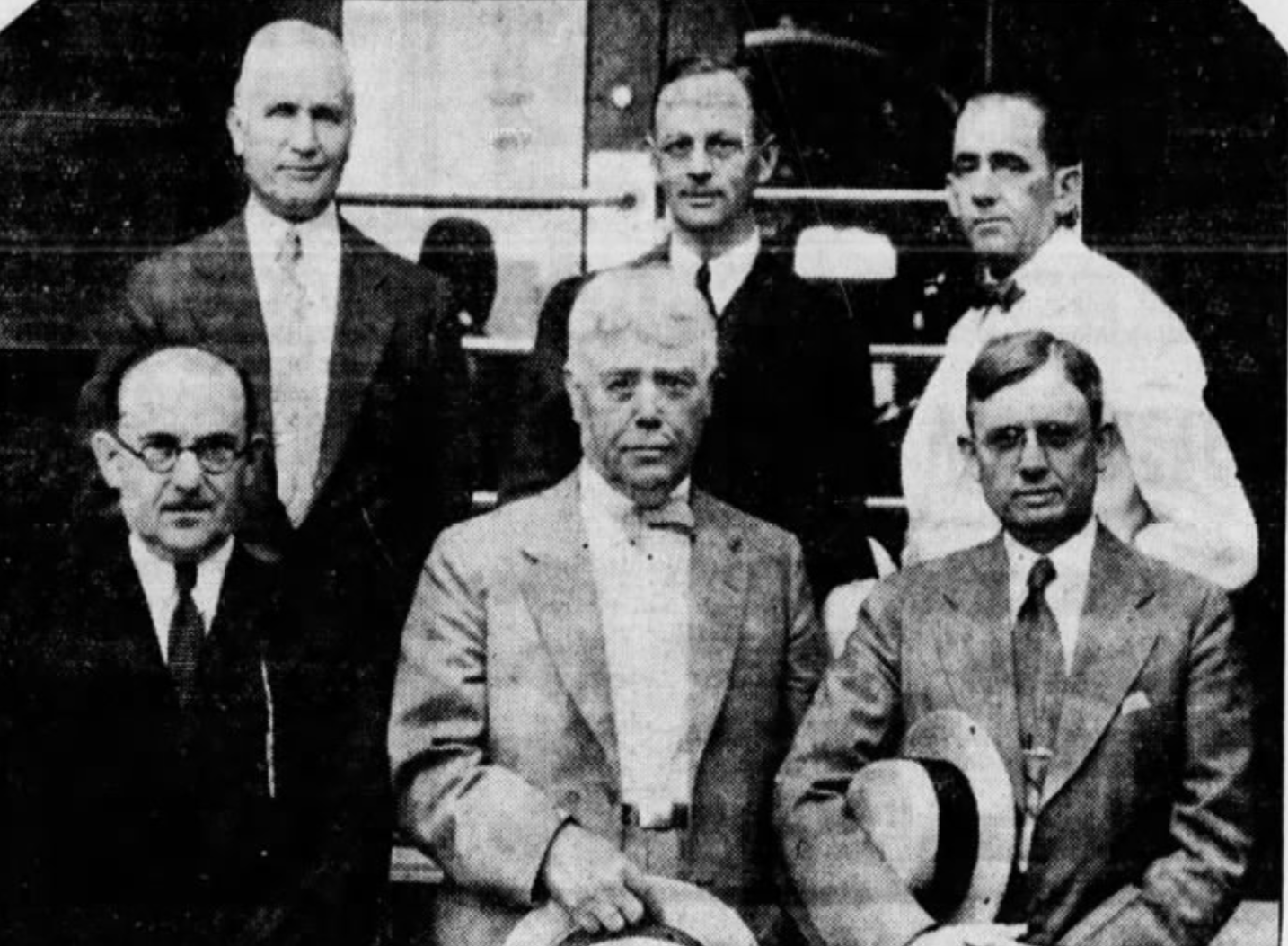 Six men stand together for a photograph.