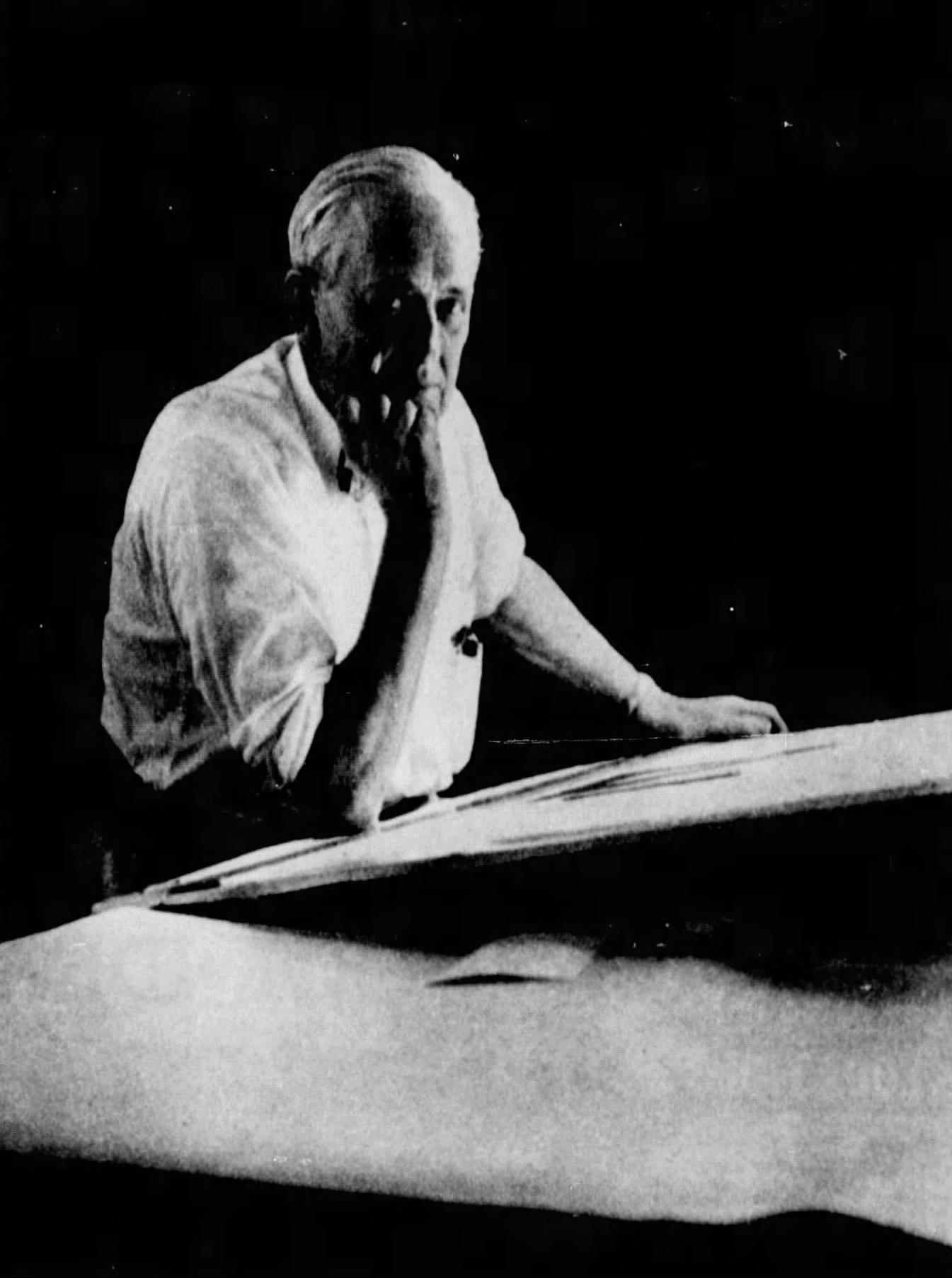 Merritt Harrison sits at a drawing desk.