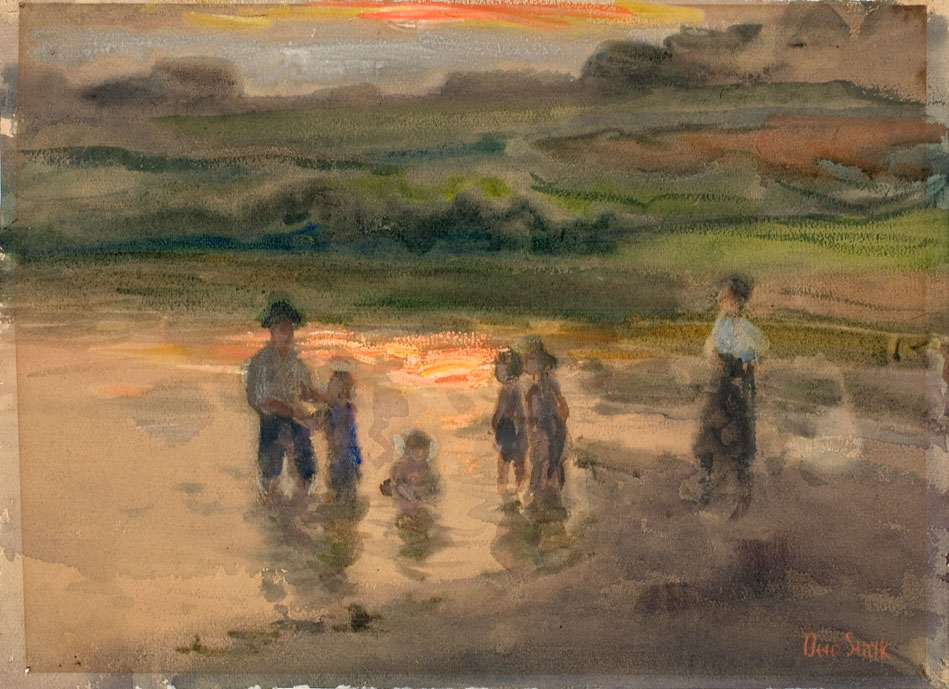 A family wades into a small body of water. 