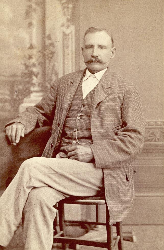 Portrait photo of Peter Lawson sitting in a chair.