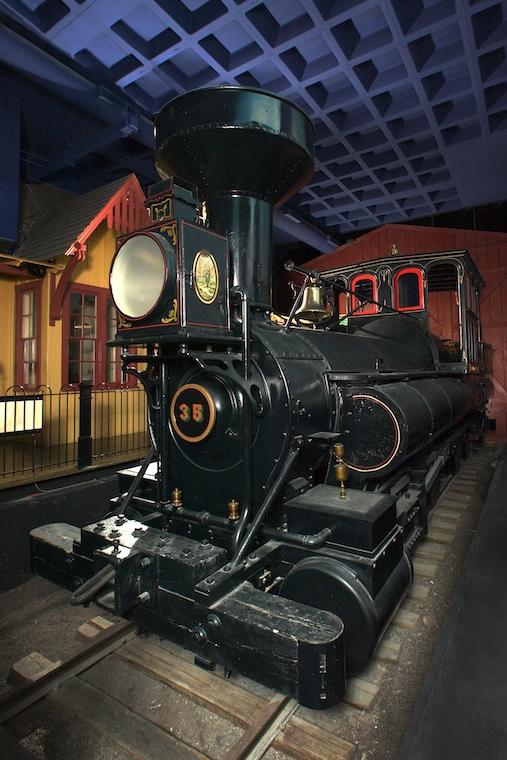 A train is inside a room in the museum. 