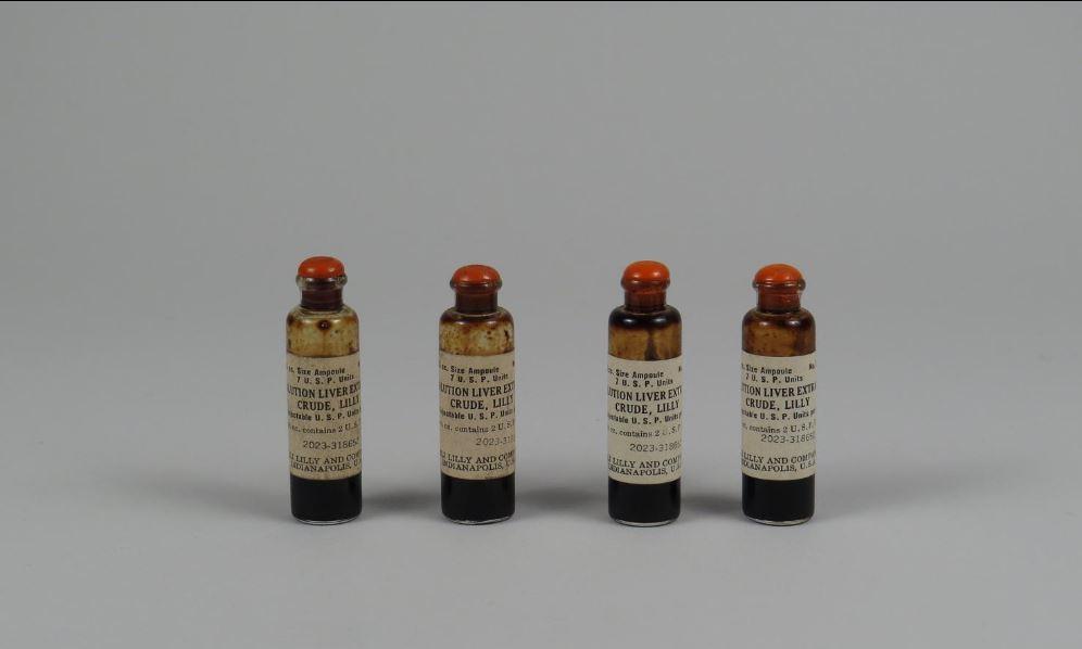 A set of four vials sitting next to each other.