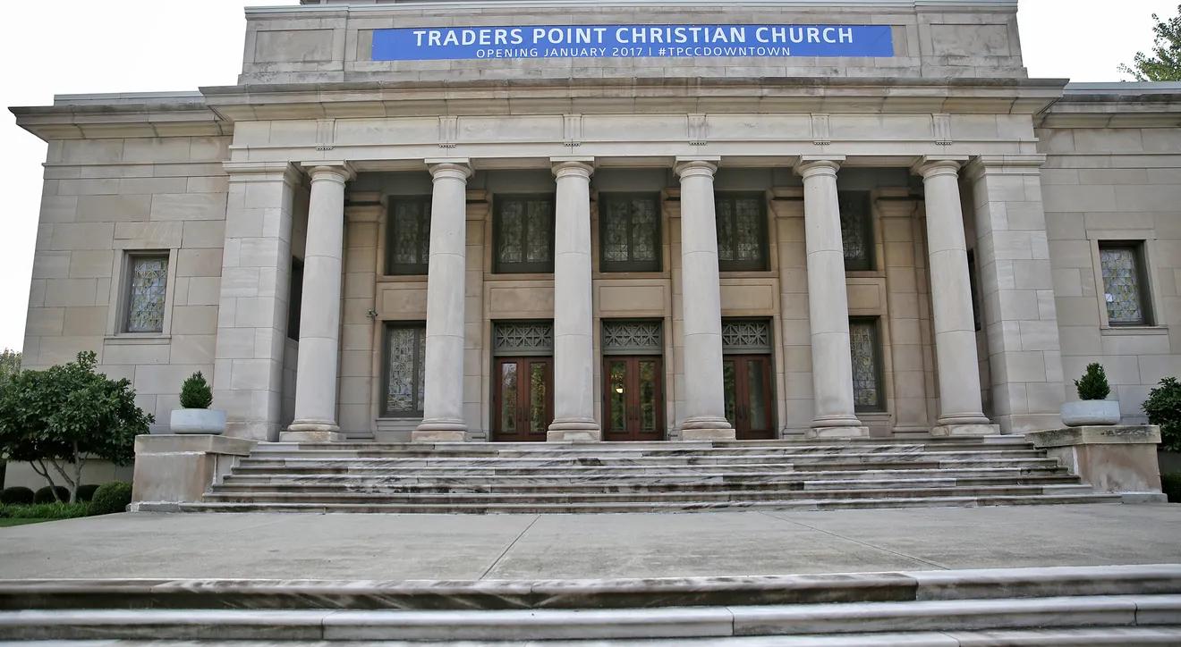 Entrance to a church. A large set of steps lead up to an entryway with several large columns.