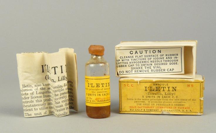 An old-fashioned pharmaceutical bottle is shown along with its packaging and instructions.
