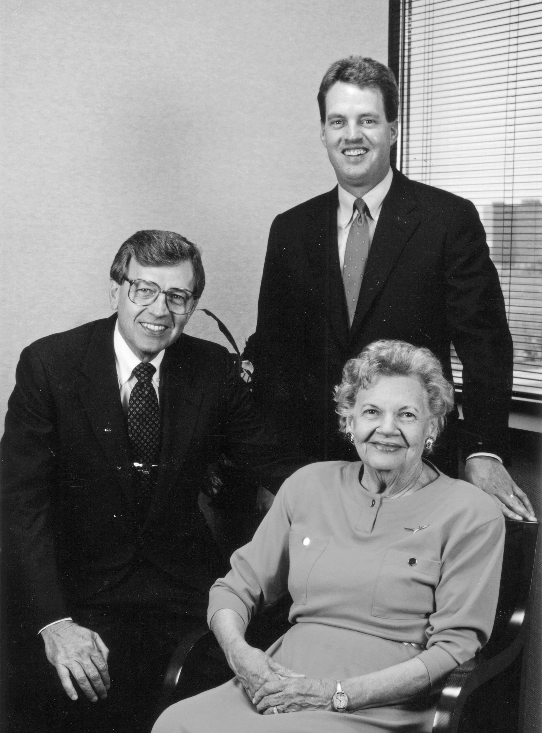 A group portrait of a woman and two men. 