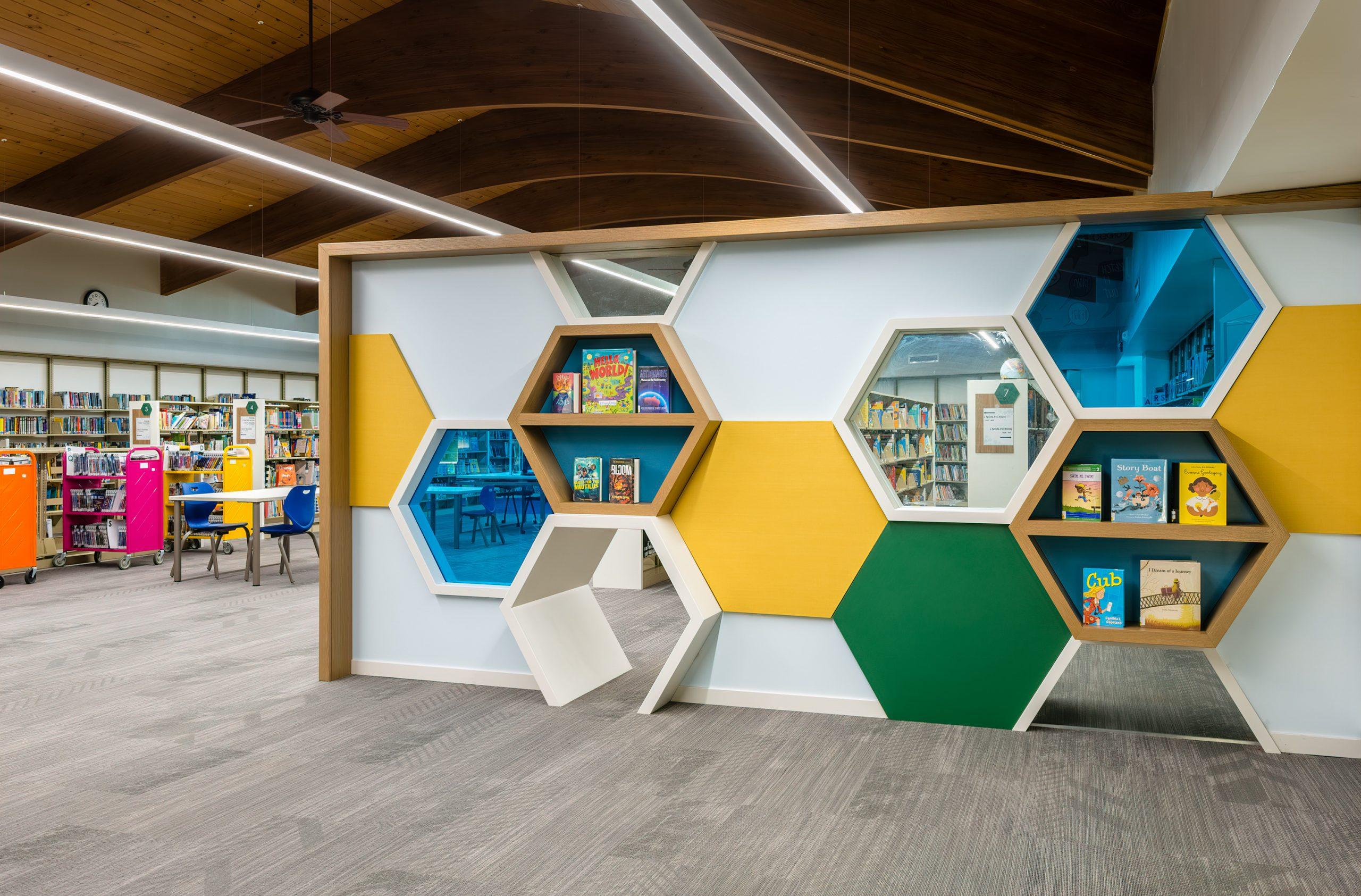 A view of a colorful wall with hexagon shaped cutouts.