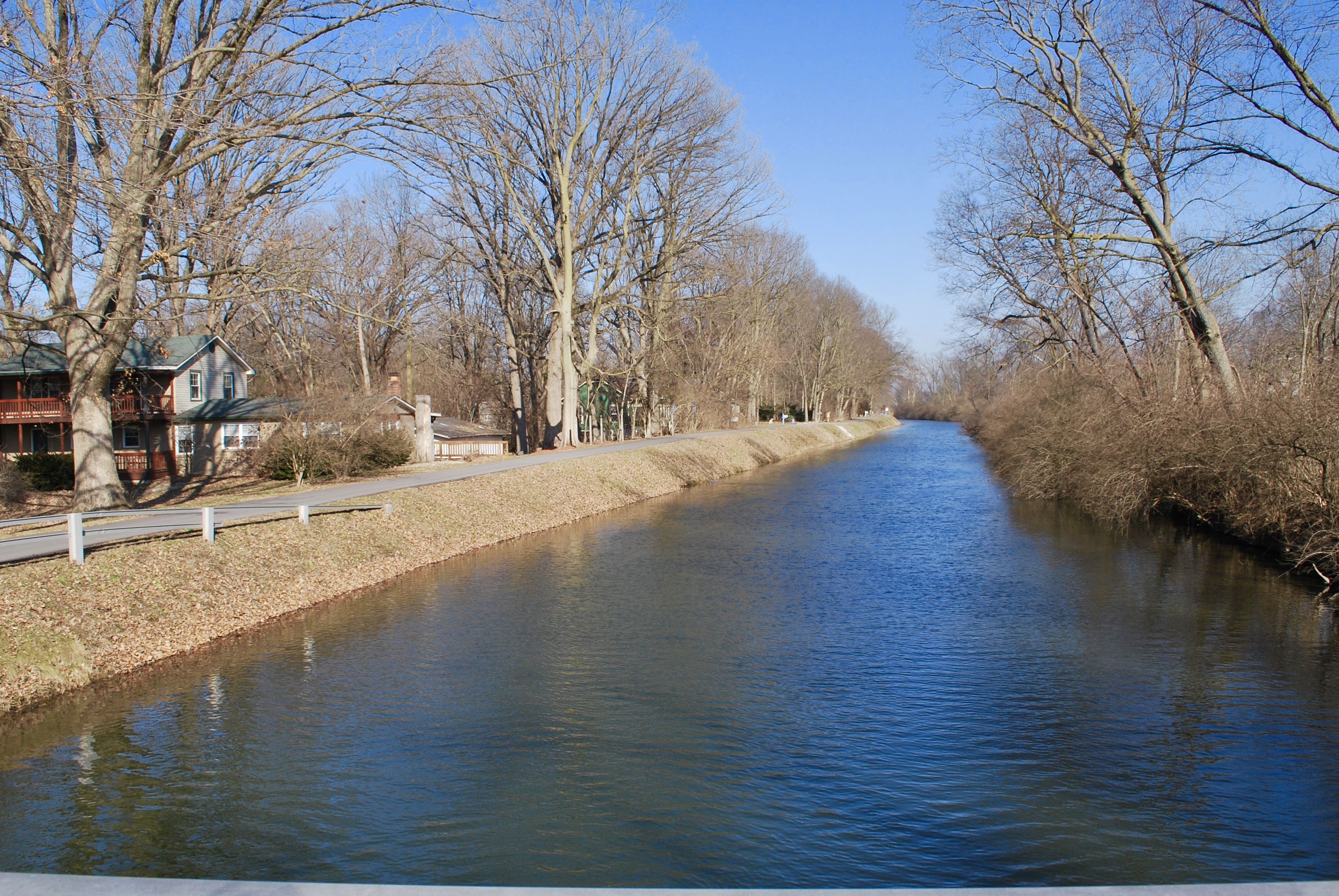 A view of a canal with houses on one side.