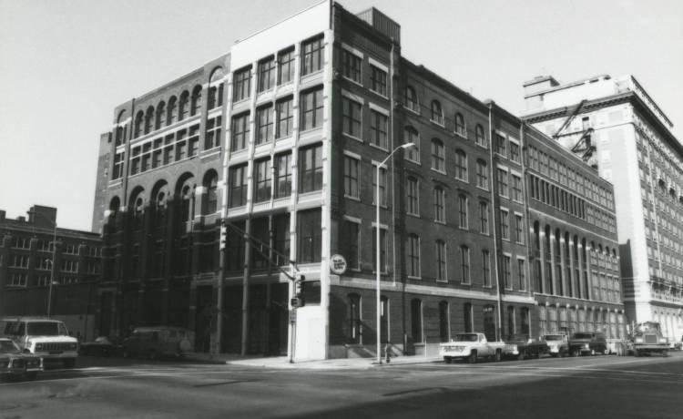 View of the southwest corner of South Meridian and Georgia Street showing a large multi-story commercial building. 