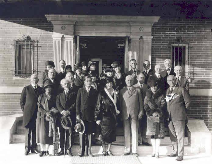 A group of people stand together outside of a building.