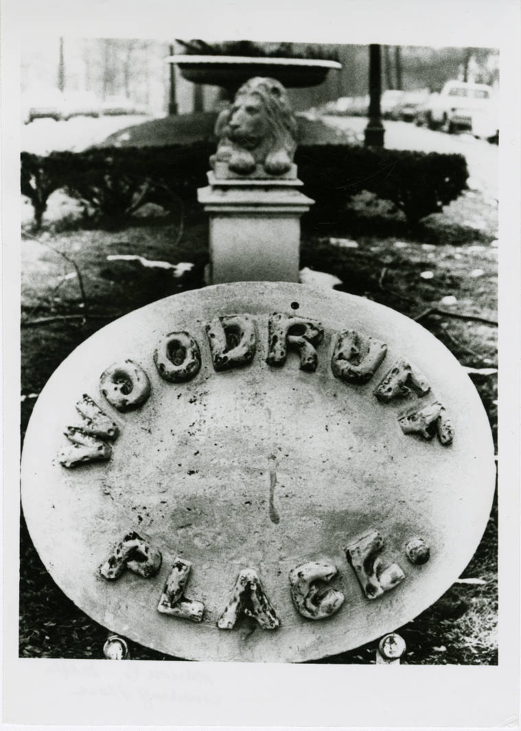 A close-up view of an oval marker with the words "Woodruff Place."