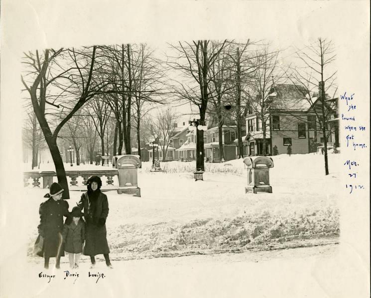 Threes girls stand outside in the snow in their neighborhood, Woodruff Place.