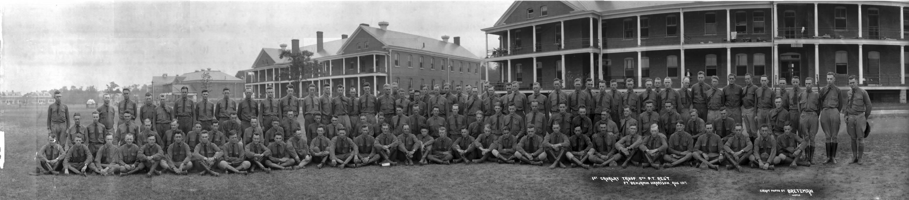 A large group of soldiers pose for photo. 