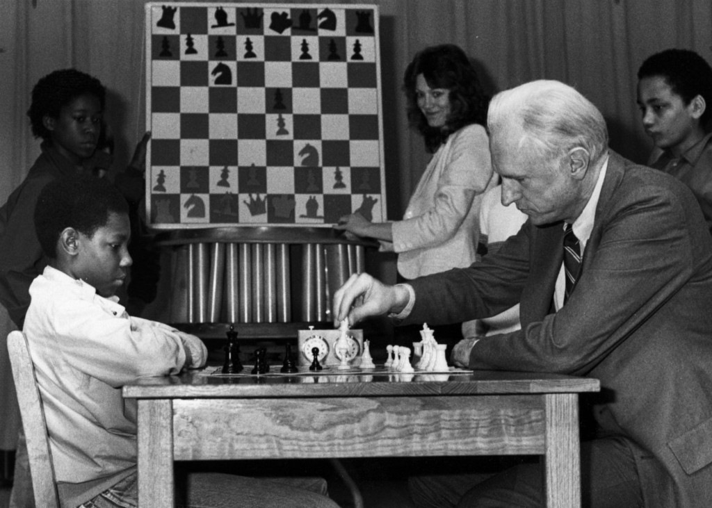Mayor Hudnut plays chess with a student from the IPS #27 chess team "Masters of Disaster," 1983