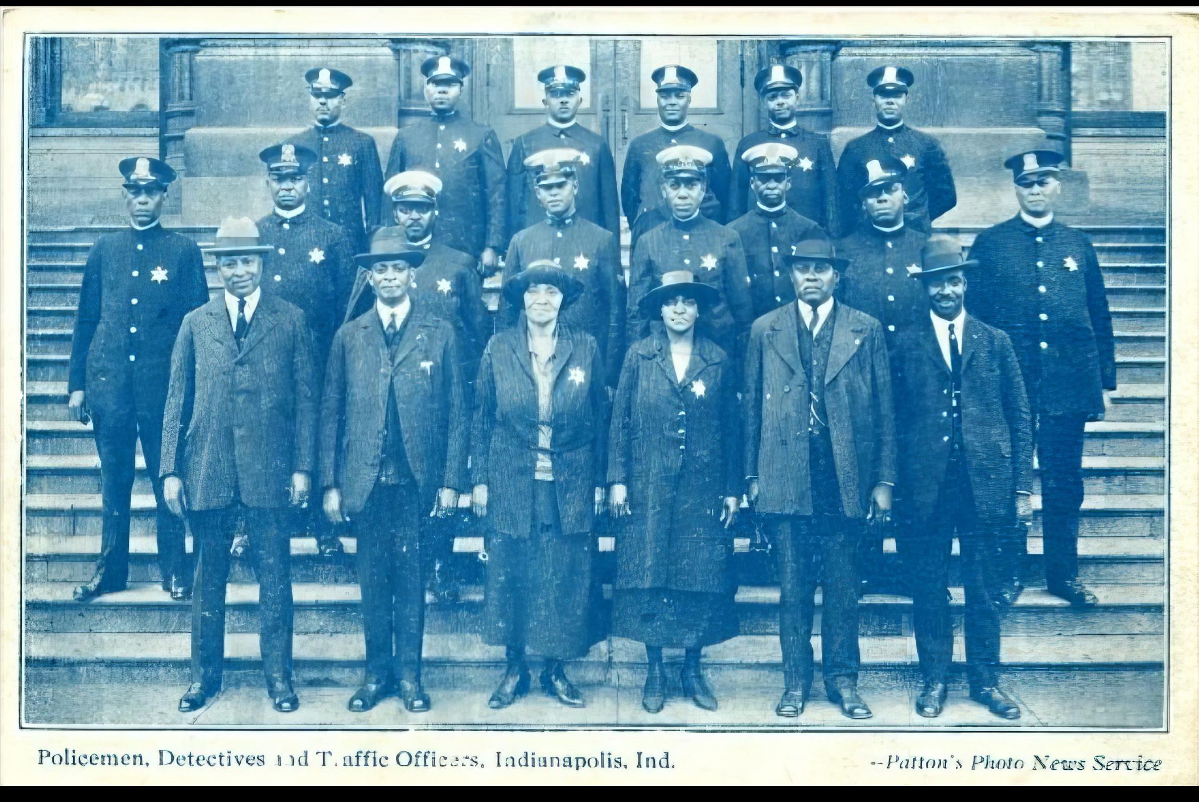 A group of Black police people standing on the steps outside of a building. 