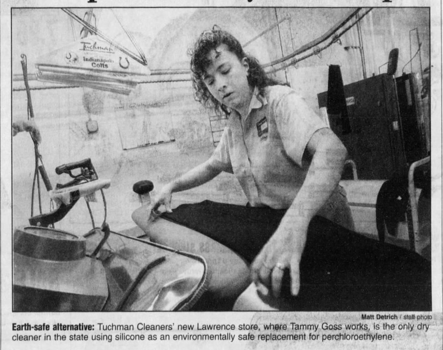 A newspaper clipping shows a woman pressing pants.