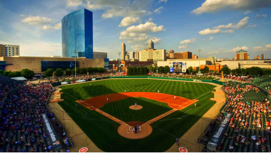 Aerial view of a baseball field with the city skyline in the background. 