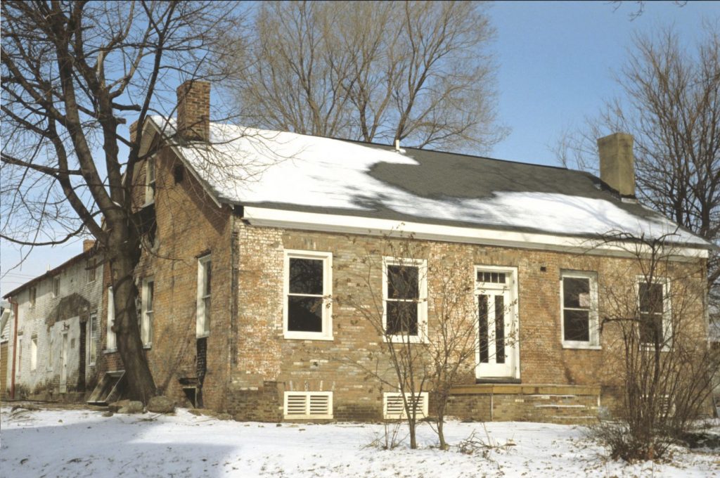 Exterior view of a brick two-story house.