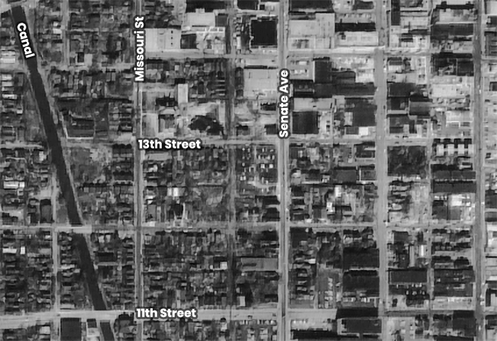 Aerial view of several city blocks. The street names are identified. 