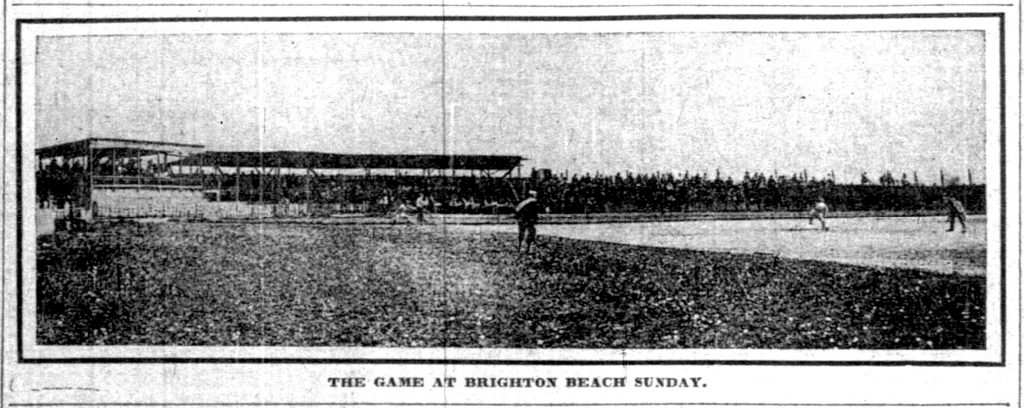 Newspaper clip showing a baseball field with people filling the stands and watching players on the field. 