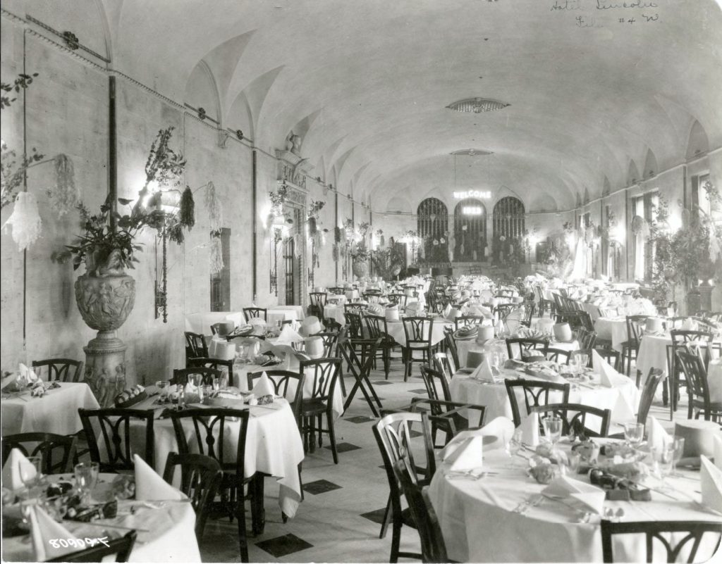 A large hall filled with round dining tables. 