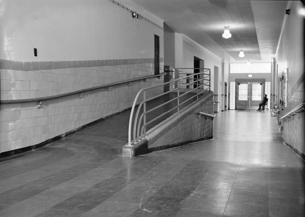 This interior photo of the James E. Roberts School shows a hallways with a ramp to accommodate wheelchairs.