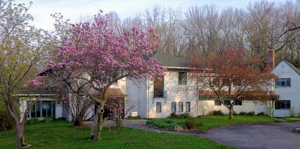 A sprawling two story building nestled in the woods.