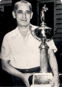 A man holds a trophy.