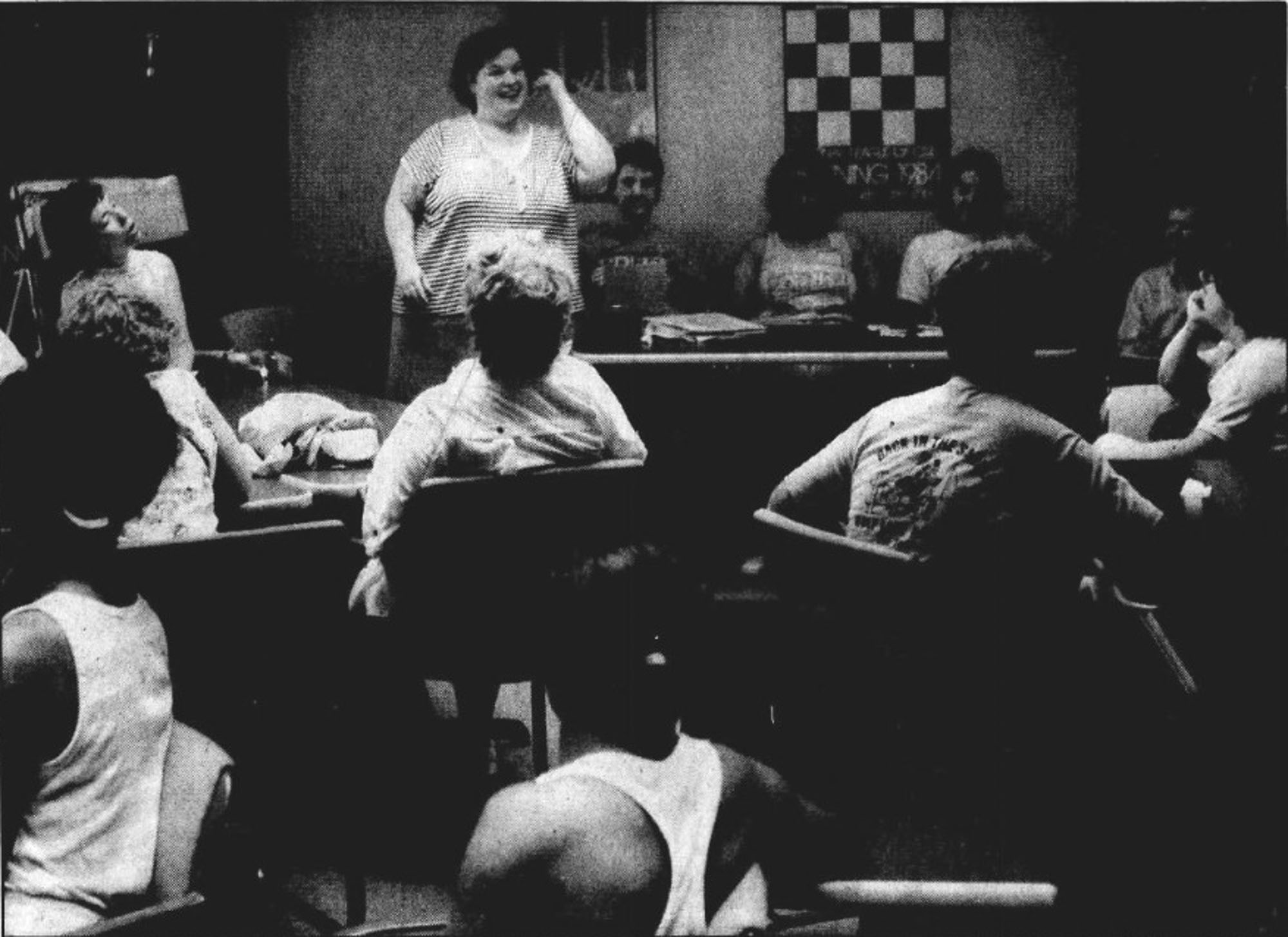 A woman gives a presentation in front of a group of people.