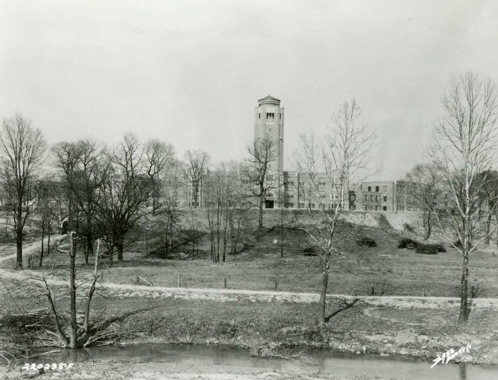 A large multi-story building with a tall central tower.