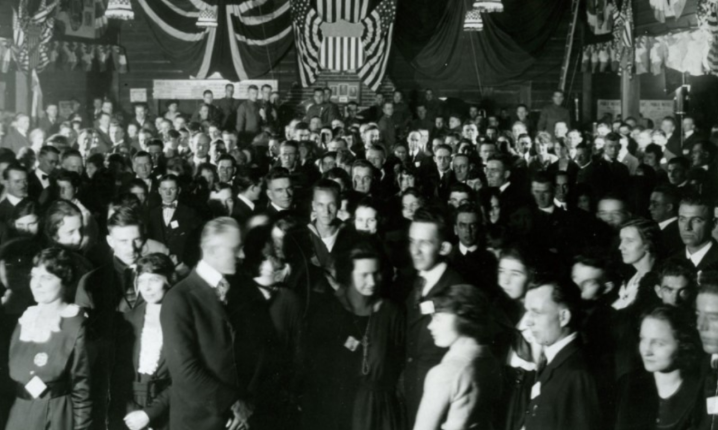 A large group of people fill a room.