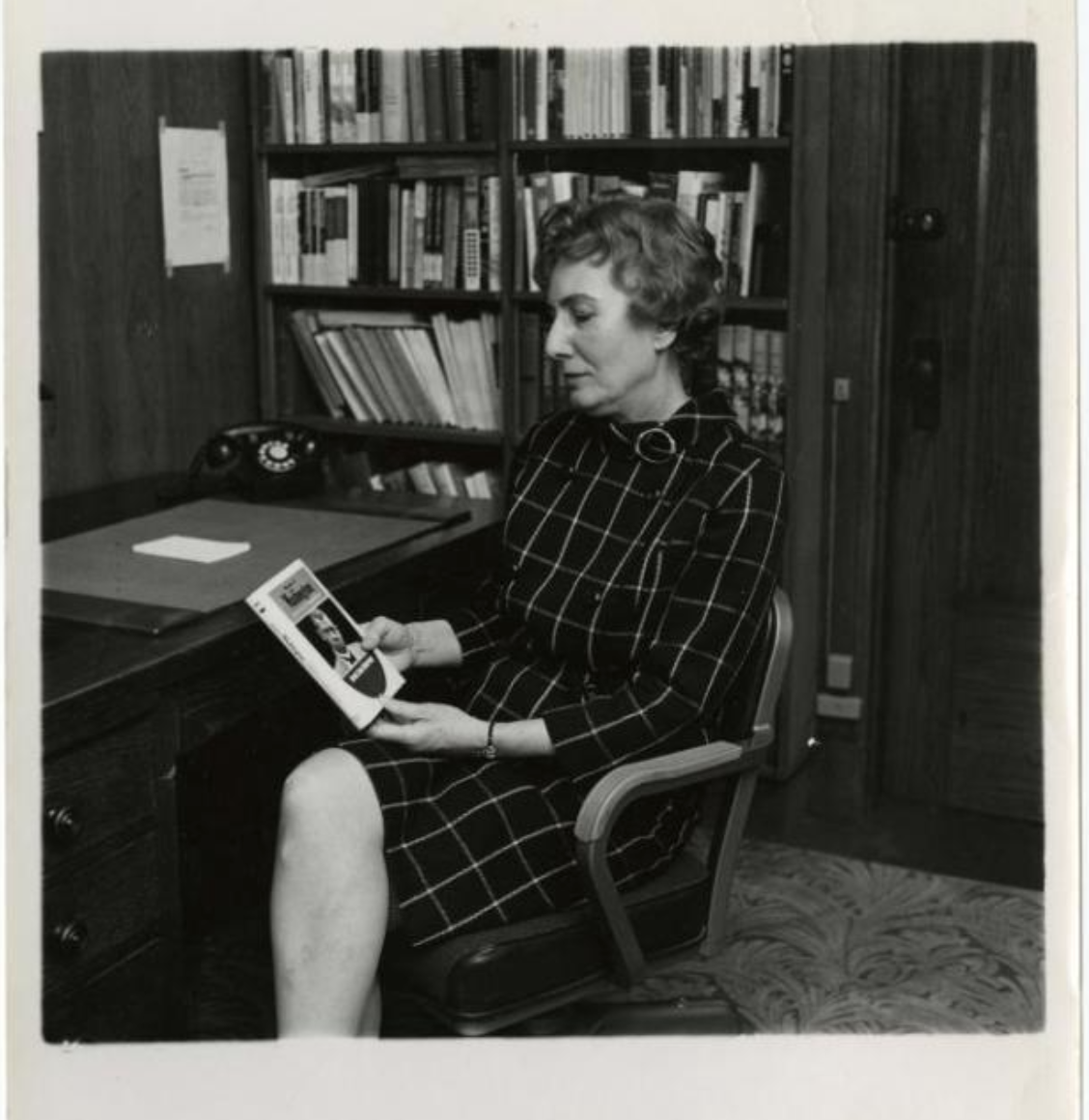 Emma Lou Thornbrough looking at the cover of the book on Booker T. Washington